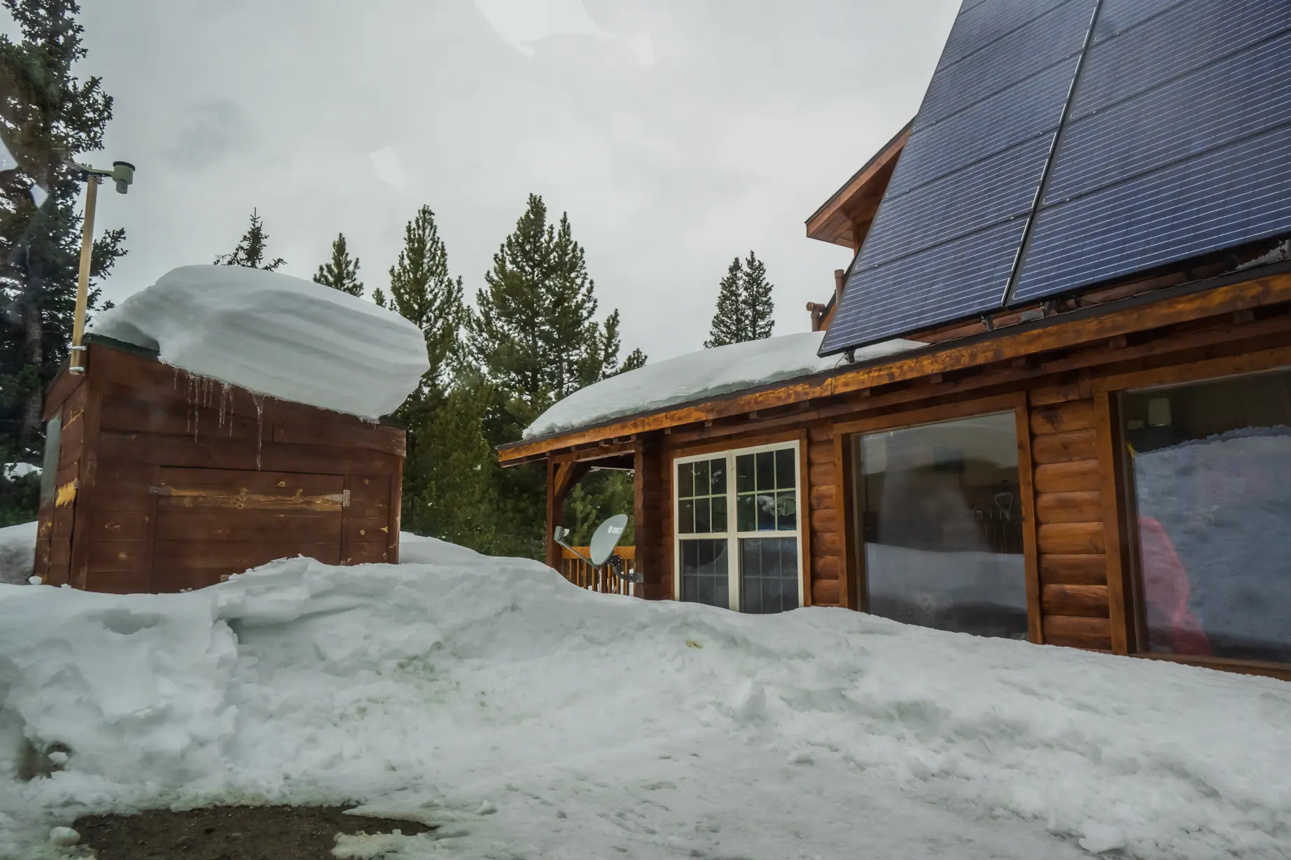 Snow-covered Colorado home with roof-mounted solar panels
