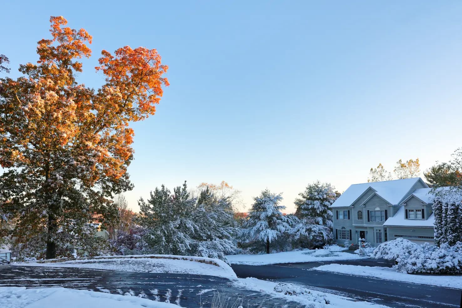 Snow-covered home with steep roofline in a Worcester, Massachusetts neighborhood